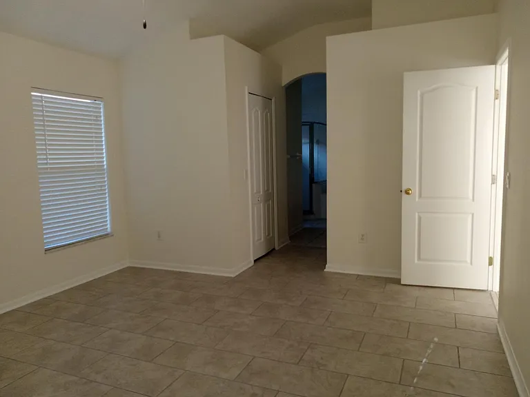Master bedroom view looking into the Master bath. Two walk in closets are located to the left and right of walkway into the Master bath.
