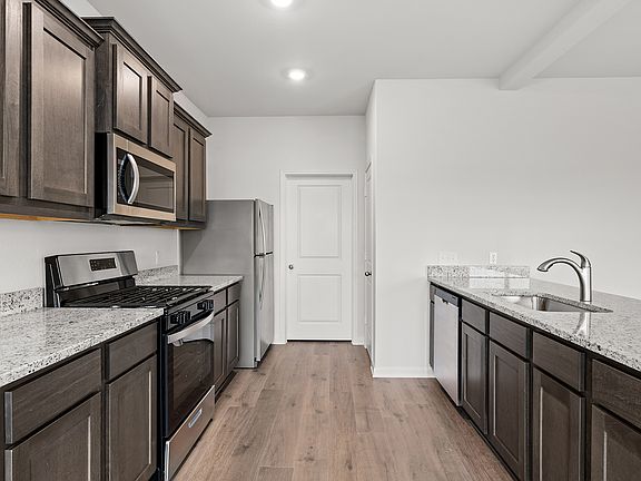The kitchen has a beautiful wood cabinetry.