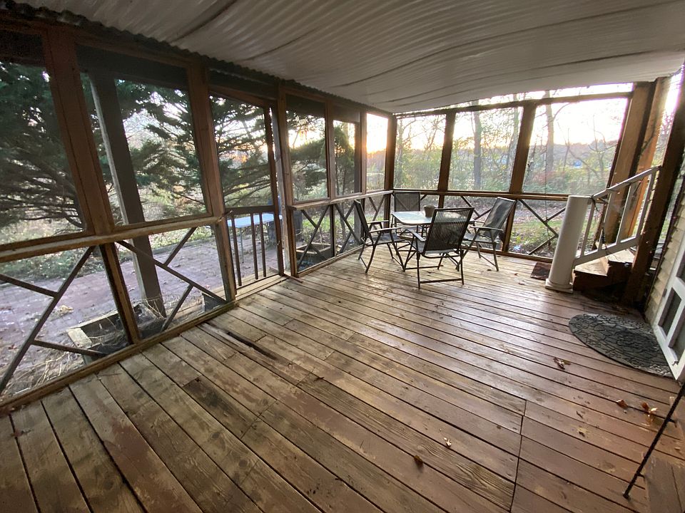 Private screened deck patio and brick patio at the entrance.