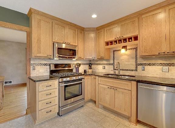Gourmet style kitchen with custom shaker style cabinets, granite counter-tops, new stainless steel a