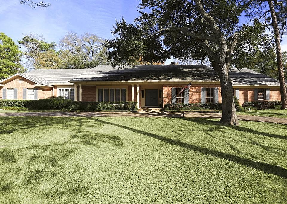 Classic and beautiful one story in fabulous Hunters Grove location on wooded 25,600 Hunters Creek Village lot.