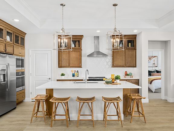 Kitchen with pendant lighting and glass upper cabinets