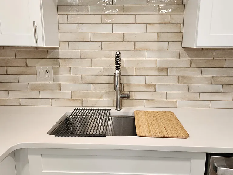 Beautiful subway tile backsplash all around.