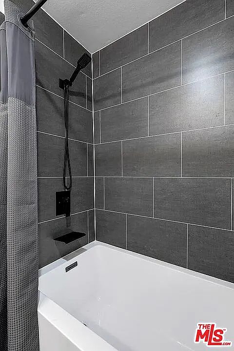 Newly remodeled bathroom with large bathtub.