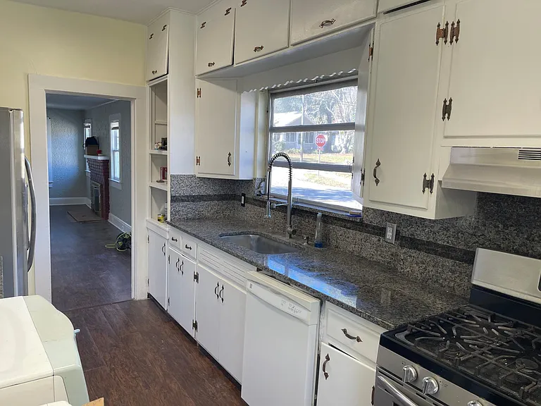 Kitchen with lots of storage granite counter tops.