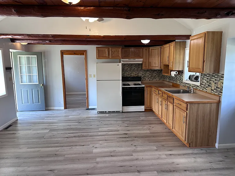 Kitchen living area looking towards larger bedroom.