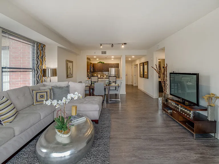 Step into a living room with stunning wood-style flooring that enhances the space with timeless charm.