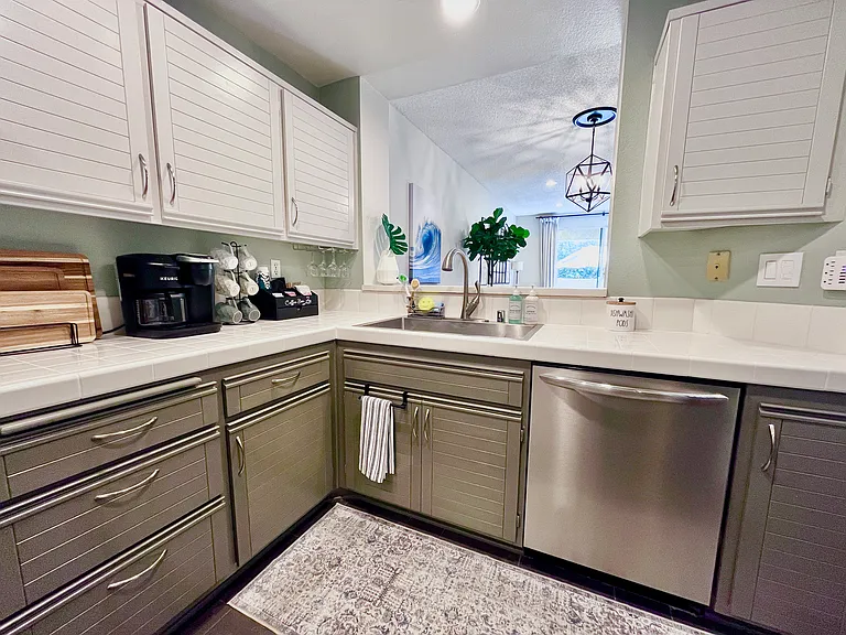 Spacious Fully Equipped Kitchen with Beverage Bar, Farmhouse Sink, and large Dishwasher. Direct access from attached garage. Additional covered across from garage.