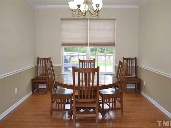 Bright dining room area with plenty of space for additional chairs, guests, buffet cabinet and more!