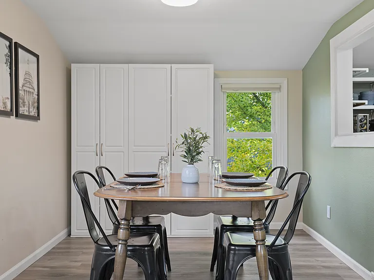 Dining room with 4 spots, and ample storage with floor to ceiling storage shelves.