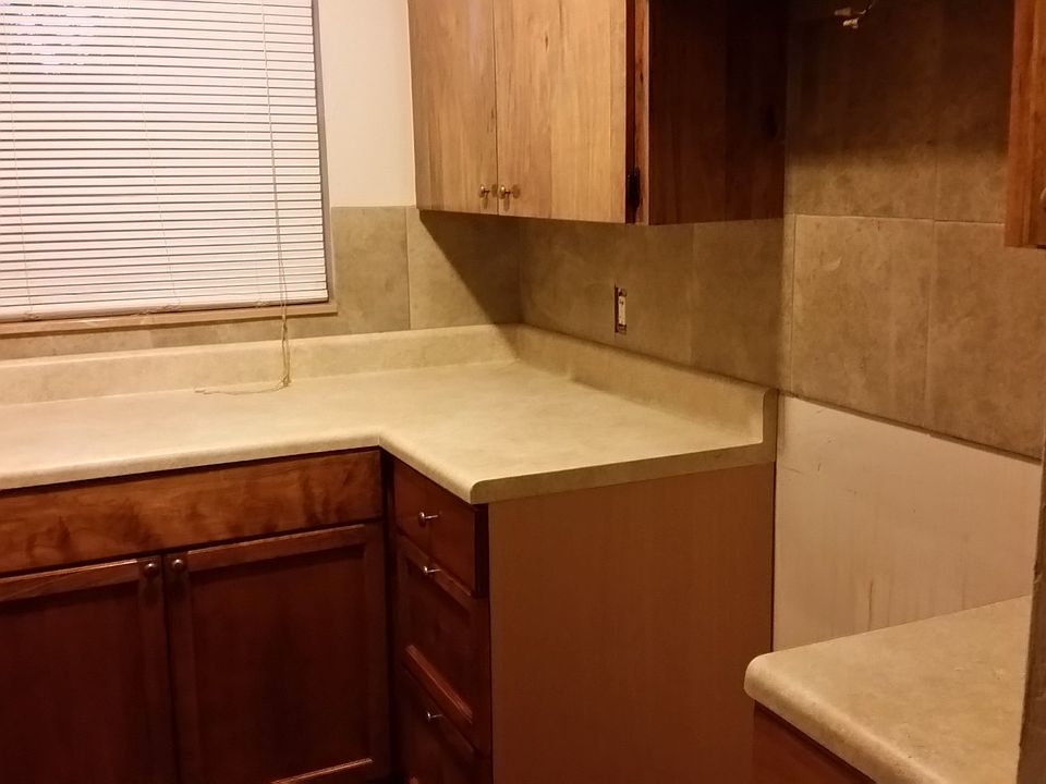 Kitchen showing backsplash of another 1 bed unit to give per