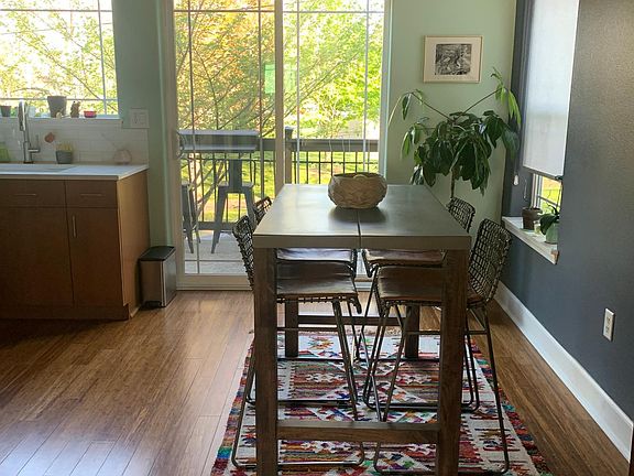 Counter height dining table and seating with sliding doors lead you to the balcony.