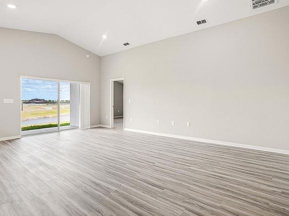 This home features a sunny, open living area with volume ceilings - Sophia by Highland Homes