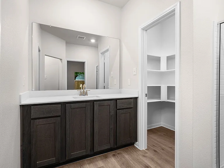 The master bathroom has a sprawling vanity.