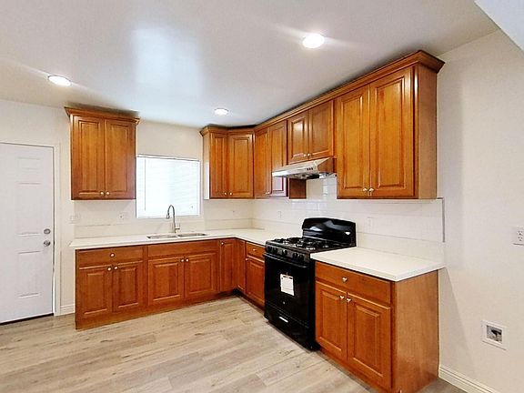 Kitchen with new stove and easy water hook-up for refrigerator