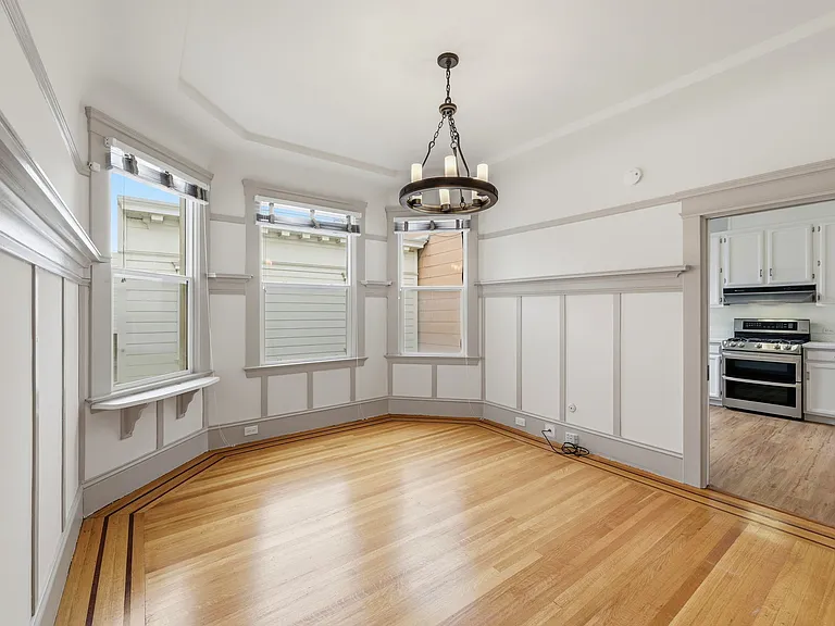Spacious living room with historical character maintained.