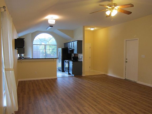 view from back door to open living/dining/kitchen