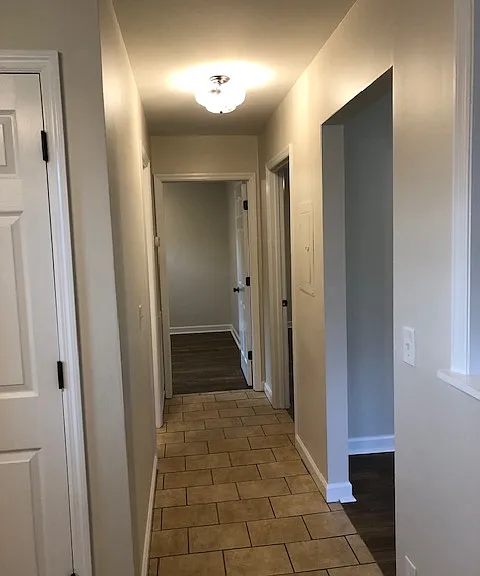 Tiled hallway to bedrooms and bath