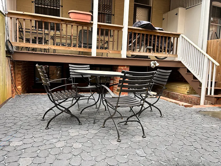 Shared patio. The trash storage area is behind the property fence (not shown).