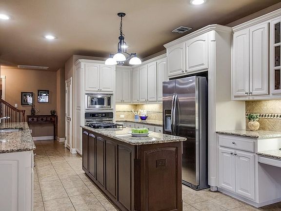 Stunning updated Kitchen boasts granite countertops, stainless steel appliances & an Island.