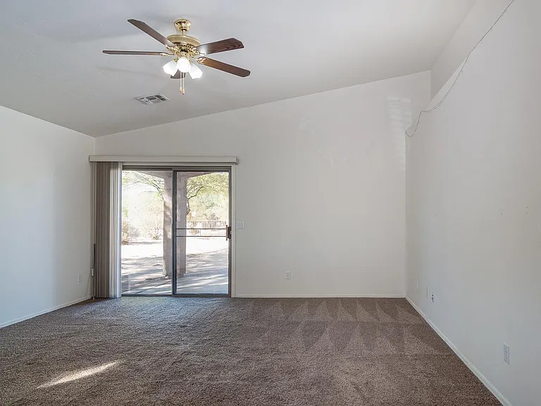 living room with a sliding door to covered patio and Catalina mountain views!