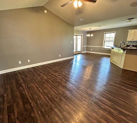 Entry way leads into the living room with vaulted ceilings and an open kitchen concept