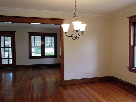 Dining Room with original hardwood floors and wood trim opens to Living Room at the front of the house.