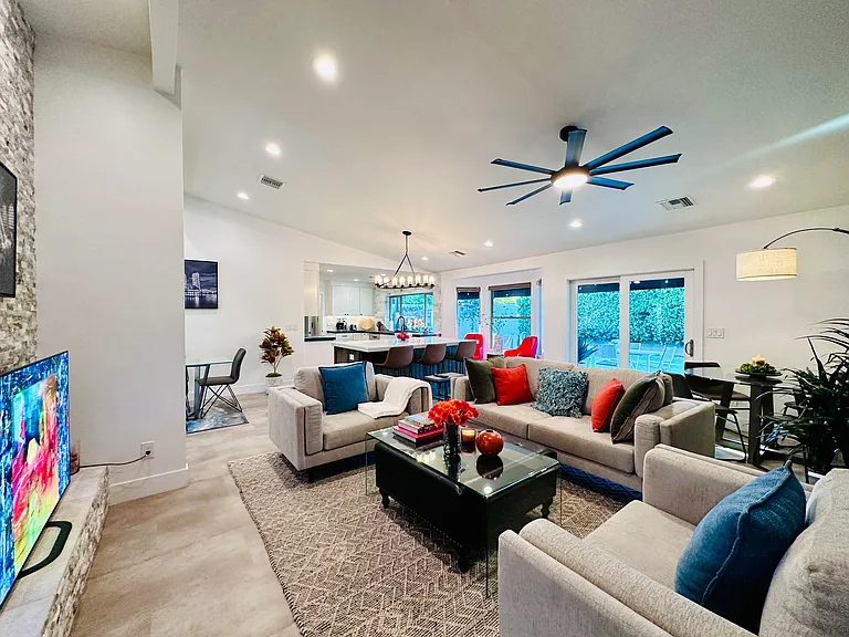 Open-Concept Living area: 
Light-filled layout featuring dramatic vaulted ceilings and sleek vinyl flooring throughout.