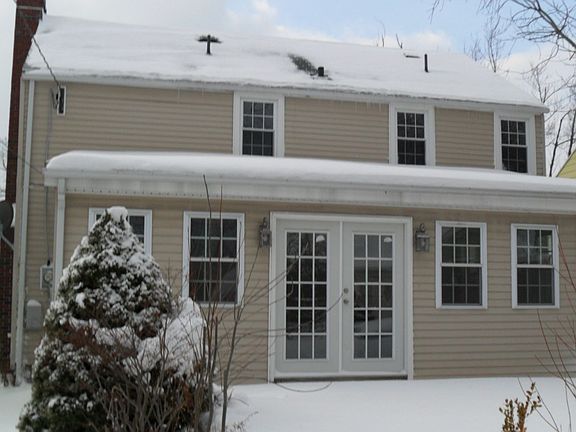Rear view of home w/french doors to patio