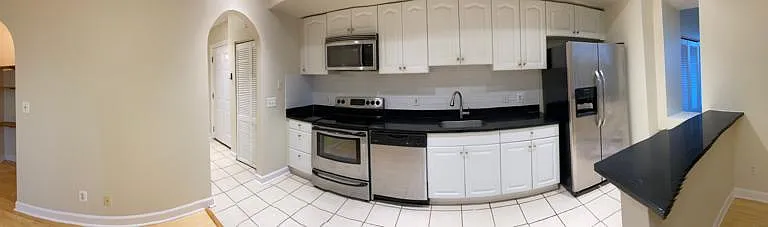 panoramic look into the kitchen and hallway