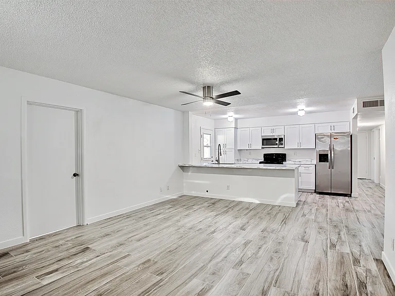 Family Room and Kitchen. Door to Bedroom 4 on the left.