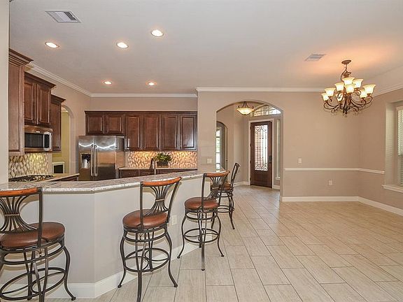 The beautiful tile flooring flows through the foyer, kitchen, dining, family, bathrooms and utility room.