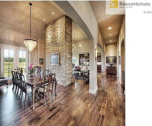 Graceful arches and open floor plan make entertaining a joy.  Note French doors off of the formal dining room leading to the back deck.