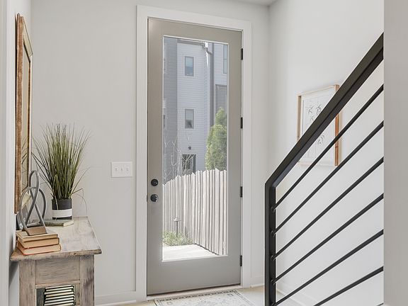 Bright and welcoming entryway with sleek finishes and modern rail detail_setting the tone for clean, contemporary living from the moment you arrive.