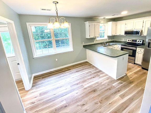 Dining and kitchen areas - peek into laundry on the left.
