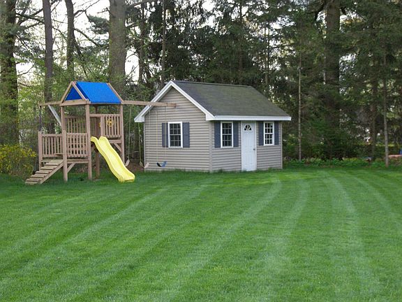 Flat yard with a shed and swing set