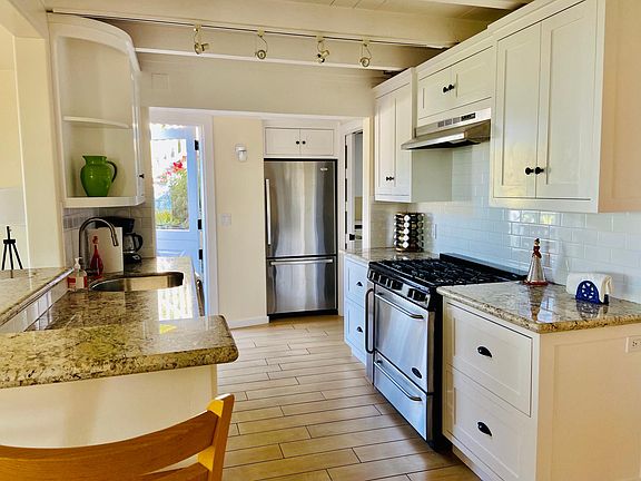 Well appointed kitchen with six burner gas stove