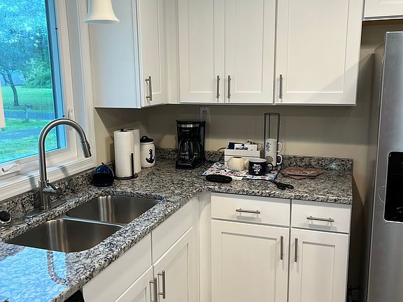 Kitchen has stainless steel appliances, ample cabinet space, and granite counter tops.