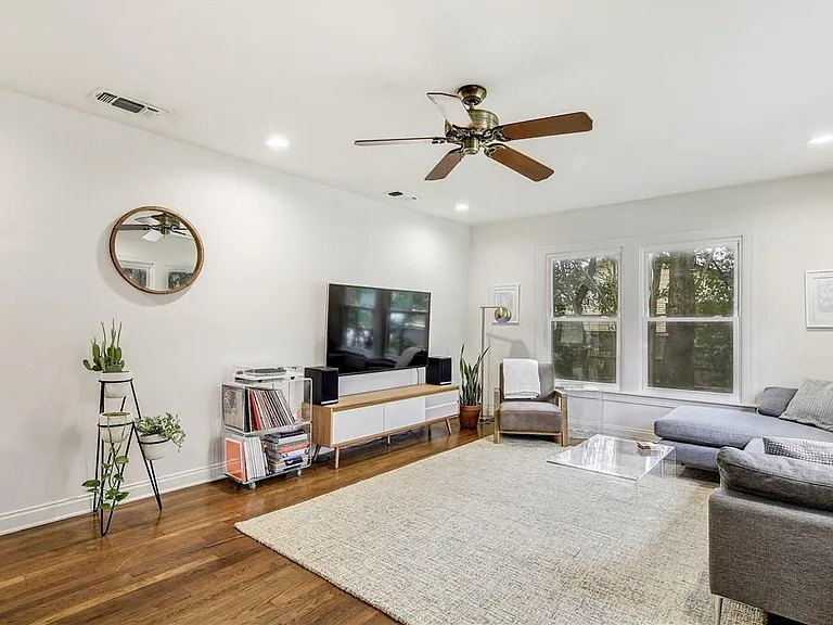 Bright Open Concept Living Room with Large Windows, Ceiling Fan, Hardwood Floors