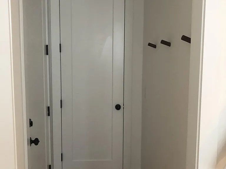 Door to garage and coat closet.