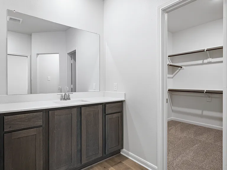 The master bathroom has a sprawling vanity space.