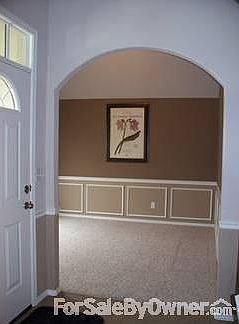 Formal Dining Room
						:
						L: front entry door with arched window overhead.