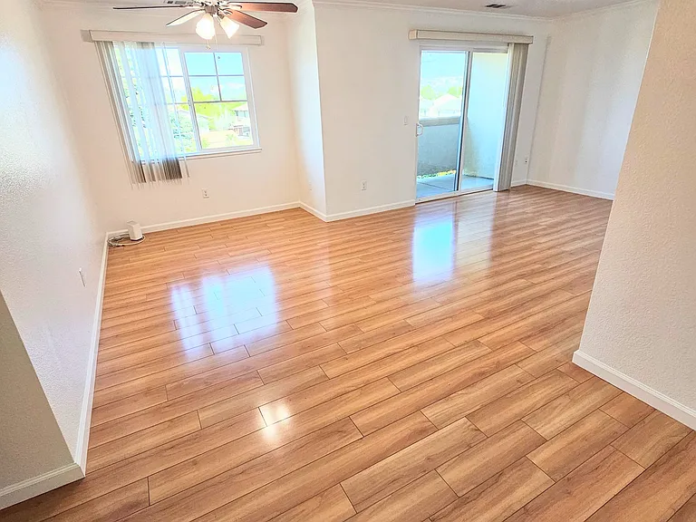 Open concept floor plan, designed with ceiling fan above the dining area, living room and balcony. All homes feature dual pane windows and sliding doors