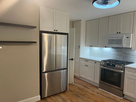 Pantry with roll-out drawer, roll out drawers in the lower cabinet for easy access to your pots & pans. Extra storage above the fridge for lighter bulky items