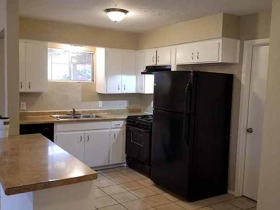 Kitchen with dishwasher, stove and fridge
