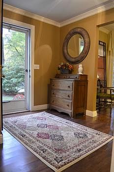 Come on in! The open foyer area connects the formal dining room and the family room. The crown moldi