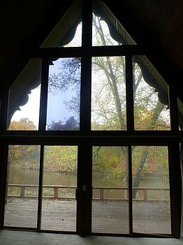 Cathedral Floor to Ceiling Windows in the Living Room Frame the River View