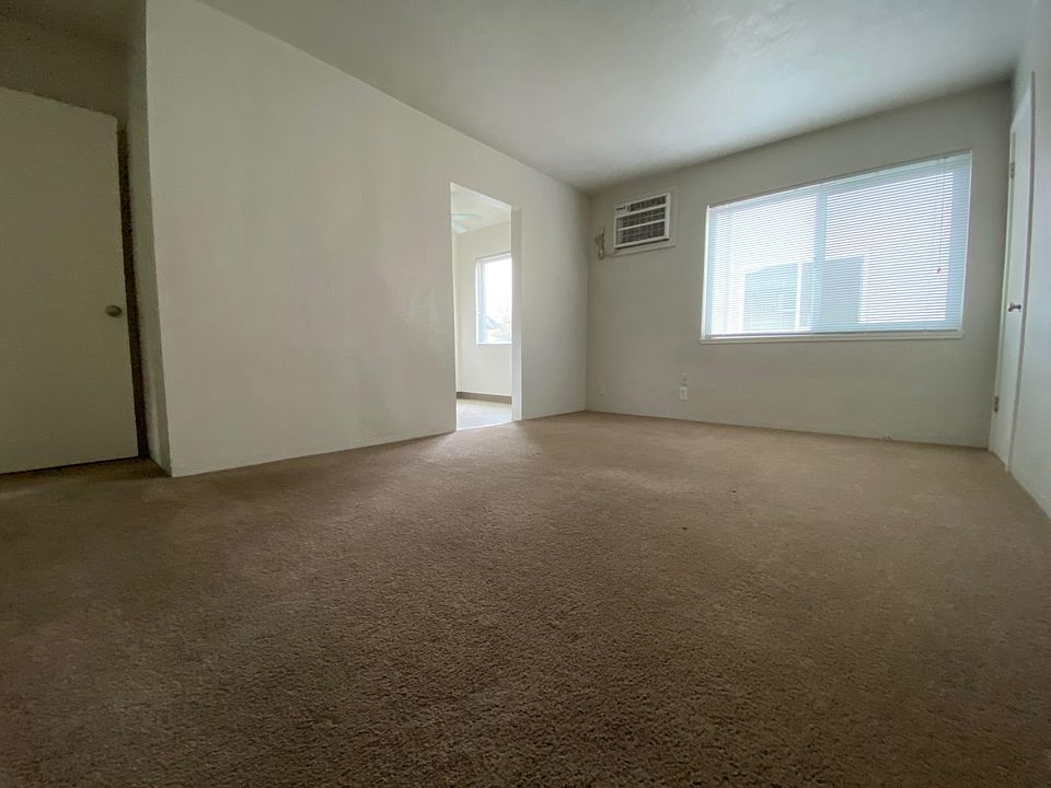 Living room from entry door. Walls are light grey.