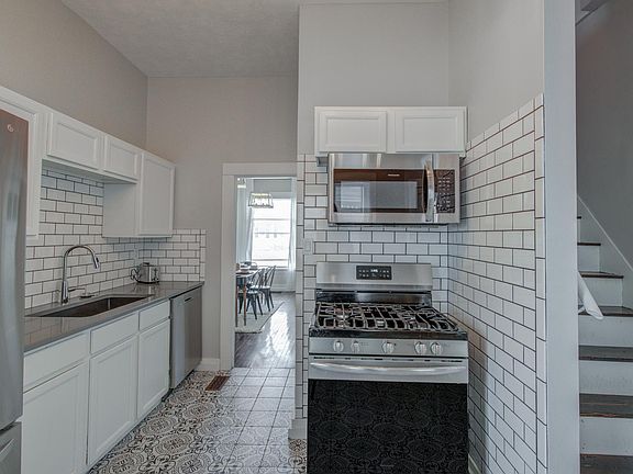 Kitchen stocked with the essentials and equipped with refrigerator, microwave, gas stove, oven and dishwasher