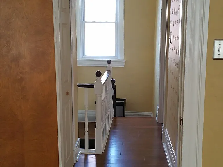 The third floor hall way is bright - and features a large closet for more storage.